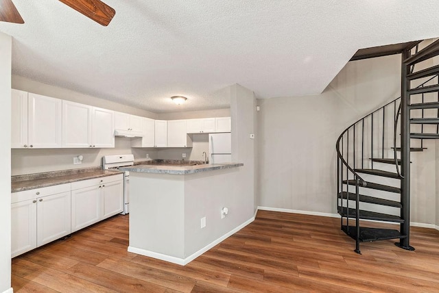 7248 72nd Ln N, Brooklyn Park, MN 55428 - kitchen with white appliances, under cabinet range hood, wood finished floors, white cabinetry, and a textured ceiling