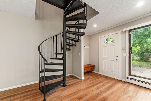 7248 72nd Ln N, Brooklyn Park, MN 55428 - foyer entrance with light wood-style flooring, a baseboard radiator, stairs, a textured ceiling, and recessed lighting