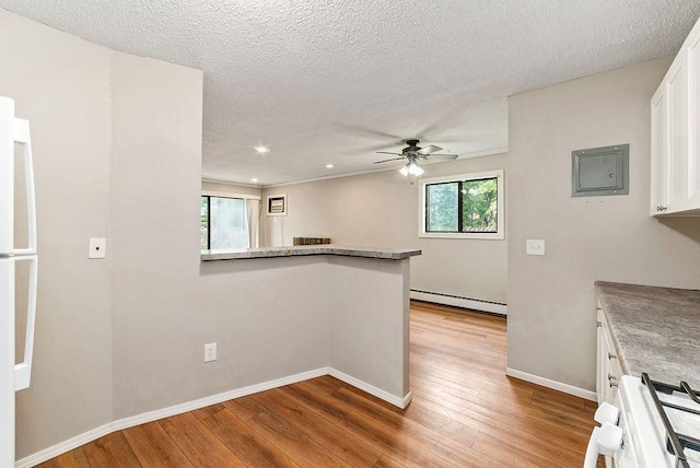 7248 72nd Ln N, Brooklyn Park, MN 55428 - kitchen featuring a baseboard heating unit, stove, healthy amount of natural light, a ceiling fan, and a textured ceiling