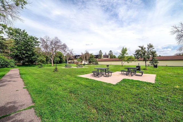 7248 72nd Ln N, Brooklyn Park, MN 55428 - view of community featuring a lawn and a patio