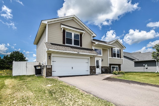 39604 Fallbrook Ave, North Branch, MN 55056 - view of front of property with stone siding, an attached garage, driveway, and a front lawn