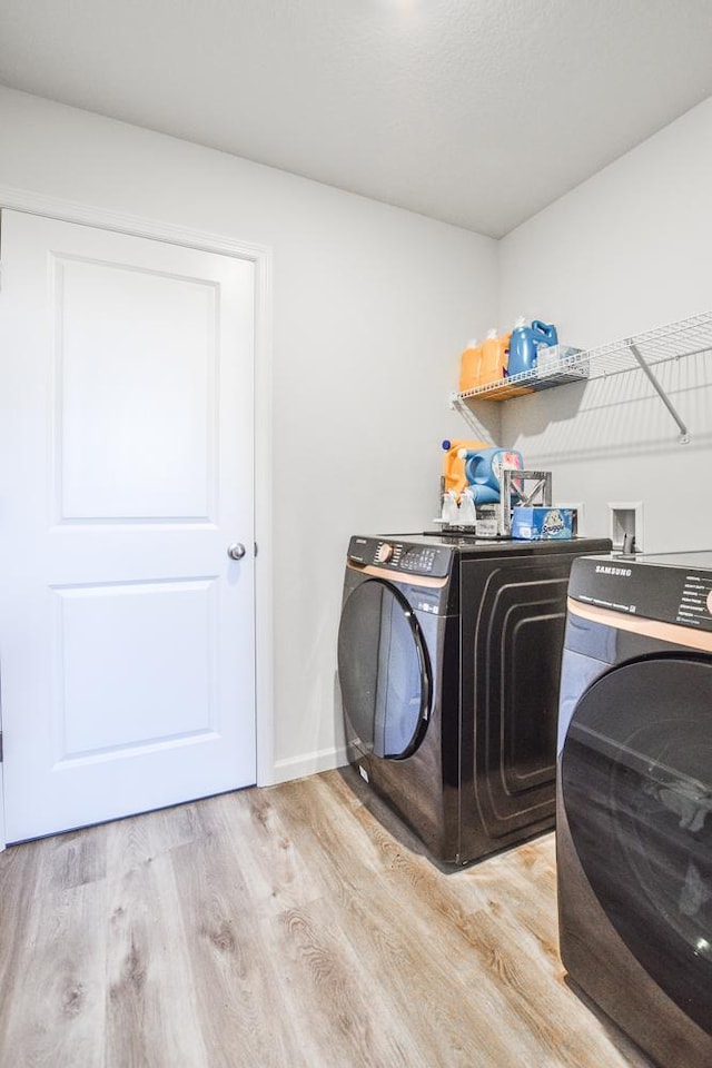 39604 Fallbrook Ave, North Branch, MN 55056 - washroom with washer and dryer and light wood-type flooring