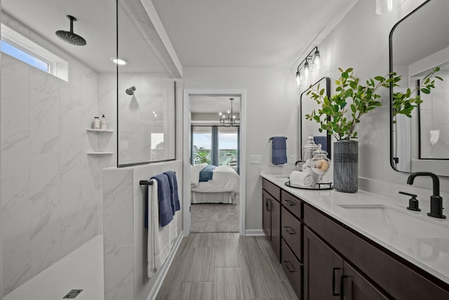 7249 Large Ave NE, Otsego, MN 55301 - ensuite bathroom featuring double vanity, a marble finish shower, and healthy amount of natural light