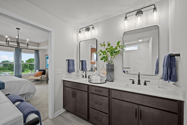 7249 Large Ave NE, Otsego, MN 55301 - full bath featuring ensuite bath, double vanity, plenty of natural light, and a chandelier