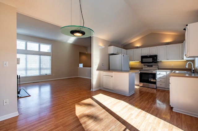 602 Cortland Ln SW, Rochester, MN 55902 - kitchen featuring electric stove, black microwave, freestanding refrigerator, white cabinets, and wood finished floors