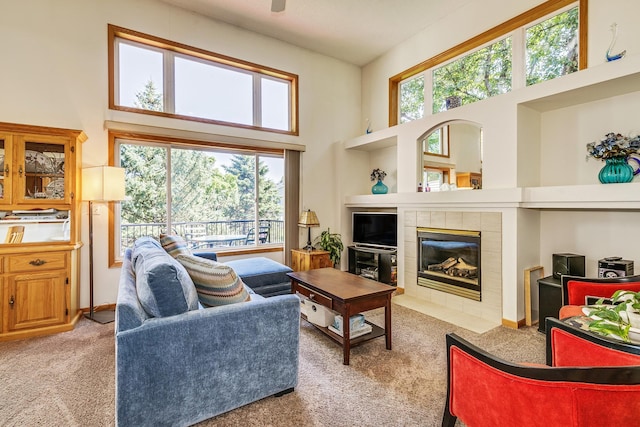 15126 Cimarron Way, Rosemount, MN 55068 - living room featuring a high ceiling, light colored carpet, and a tile fireplace
