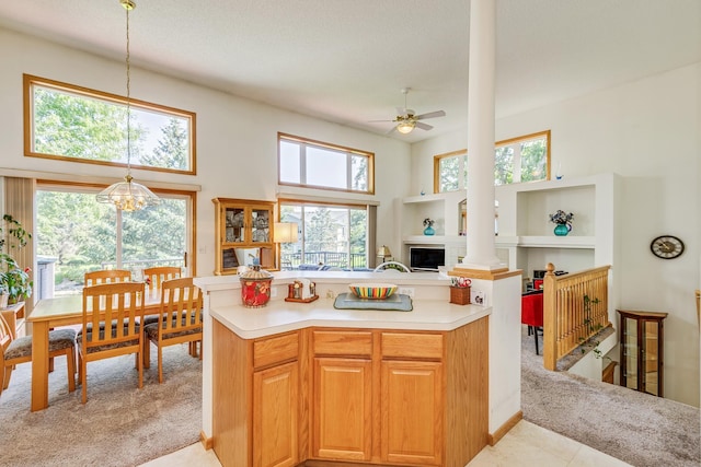 15126 Cimarron Way, Rosemount, MN 55068 - kitchen featuring healthy amount of natural light, light countertops, ceiling fan, decorative light fixtures, and a towering ceiling