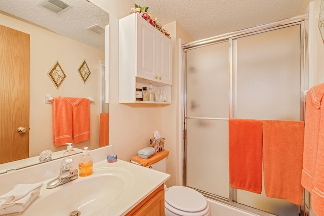 15126 Cimarron Way, Rosemount, MN 55068 - bathroom with a textured ceiling, vanity, and a shower with door