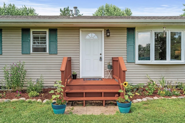 7635 165th Ave NE, Columbus, MN 55025 - view of exterior entry featuring a shingled roof and a wooden deck