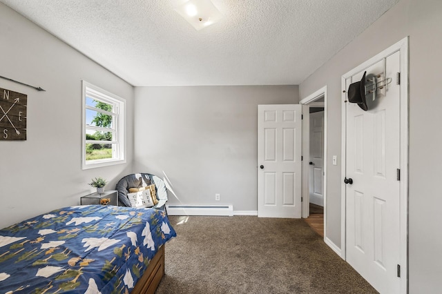 7635 165th Ave NE, Columbus, MN 55025 - carpeted bedroom featuring a baseboard radiator and a textured ceiling
