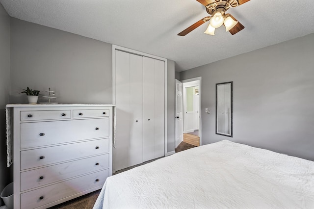 7635 165th Ave NE, Columbus, MN 55025 - bedroom featuring a closet, a ceiling fan, and dark carpet