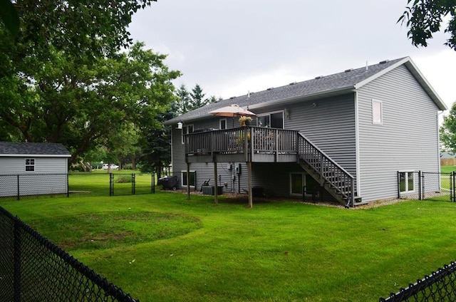 1120 Madisson St, Alexandria, MN 56308 - back of house featuring stairway, a wooden deck, a fenced backyard, and a gate