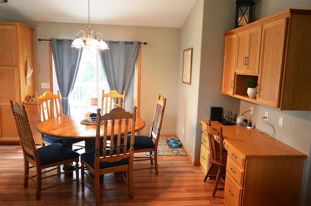 1120 Madisson St, Alexandria, MN 56308 - dining space featuring a chandelier, light wood-type flooring, and built in desk