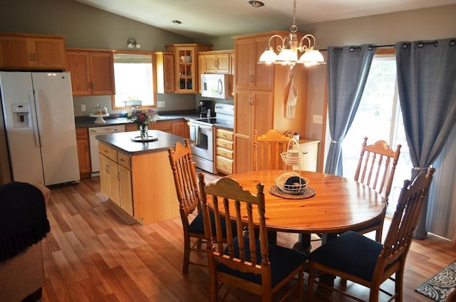 1120 Madisson St, Alexandria, MN 56308 - dining space featuring a chandelier, lofted ceiling, and light wood-style flooring