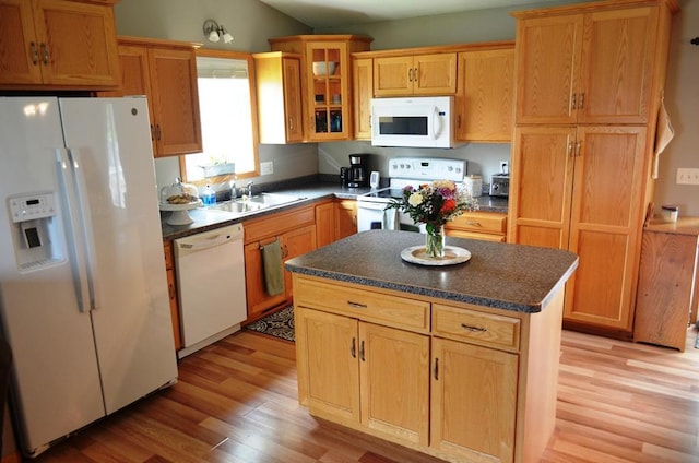 1120 Madisson St, Alexandria, MN 56308 - kitchen featuring white appliances, light wood-type flooring, dark countertops, glass insert cabinets, and a kitchen island