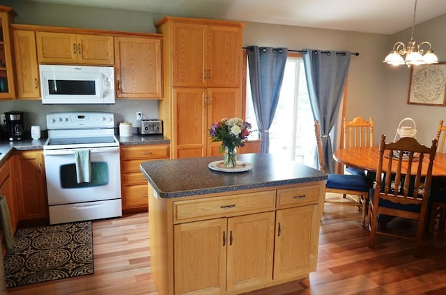 1120 Madisson St, Alexandria, MN 56308 - kitchen featuring white appliances, light wood-style floors, a chandelier, and dark countertops