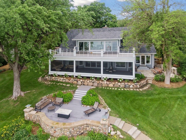 2462 Lafayette Rd, Minnetonka Beach, MN 55391 - rear view of house with a shingled roof, a patio, a lawn, and a balcony