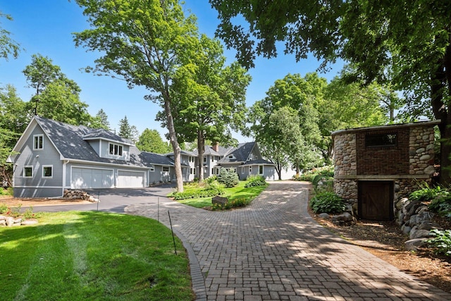 2462 Lafayette Rd, Minnetonka Beach, MN 55391 - view of front of property with a garage, driveway, stone siding, and a front lawn