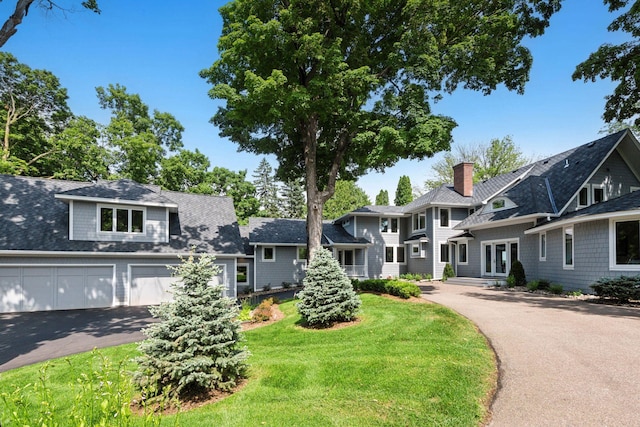 2462 Lafayette Rd, Minnetonka Beach, MN 55391 - shingle-style home with driveway, a garage, and a front lawn