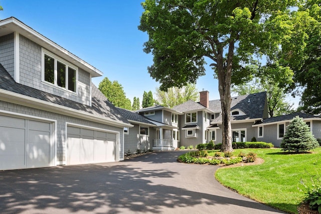 2462 Lafayette Rd, Minnetonka Beach, MN 55391 - view of front of property with driveway, a garage, and a front lawn