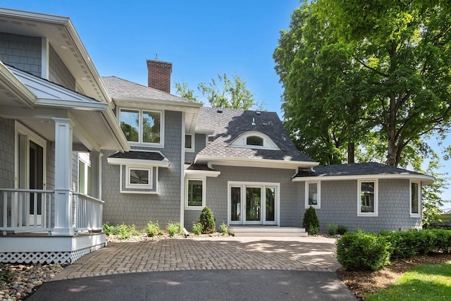 2462 Lafayette Rd, Minnetonka Beach, MN 55391 - view of front facade featuring roof with shingles and a chimney