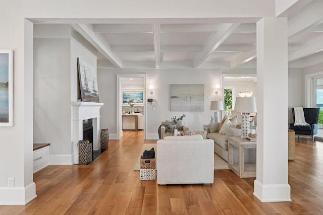 2462 Lafayette Rd, Minnetonka Beach, MN 55391 - living room with coffered ceiling, light wood finished floors, healthy amount of natural light, a fireplace, and beam ceiling