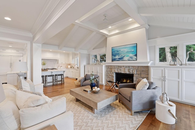 2462 Lafayette Rd, Minnetonka Beach, MN 55391 - living area with light wood-style flooring, a stone fireplace, plenty of natural light, beamed ceiling, and recessed lighting