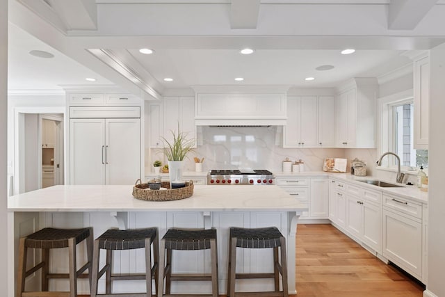 2462 Lafayette Rd, Minnetonka Beach, MN 55391 - kitchen featuring a kitchen bar, white cabinets, crown molding, backsplash, and recessed lighting