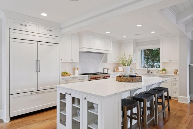 2462 Lafayette Rd, Minnetonka Beach, MN 55391 - kitchen featuring paneled built in refrigerator, premium range hood, white cabinetry, decorative backsplash, and recessed lighting