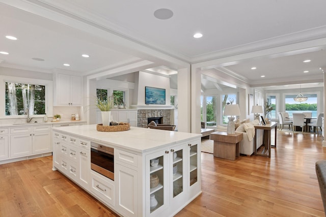 2462 Lafayette Rd, Minnetonka Beach, MN 55391 - kitchen with open floor plan, crown molding, plenty of natural light, light stone countertops, and recessed lighting