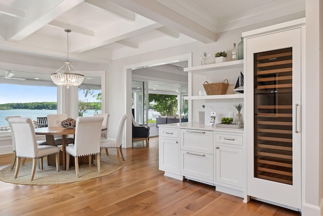 2462 Lafayette Rd, Minnetonka Beach, MN 55391 - dining area with wine cooler, a chandelier, light wood-style floors, beam ceiling, and a water view