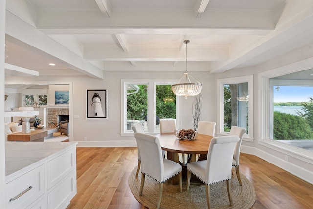 2462 Lafayette Rd, Minnetonka Beach, MN 55391 - dining space featuring beam ceiling, light wood-style flooring, a chandelier, recessed lighting, and a fireplace