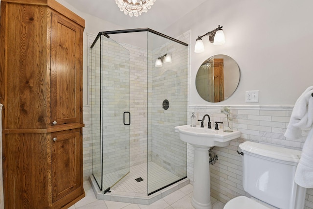 2462 Lafayette Rd, Minnetonka Beach, MN 55391 - full bathroom with a shower stall, wainscoting, tile patterned flooring, tile walls, and a chandelier
