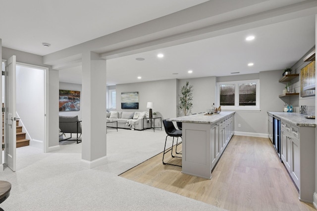 2462 Lafayette Rd, Minnetonka Beach, MN 55391 - kitchen with a breakfast bar, open shelves, wine cooler, recessed lighting, and light stone counters