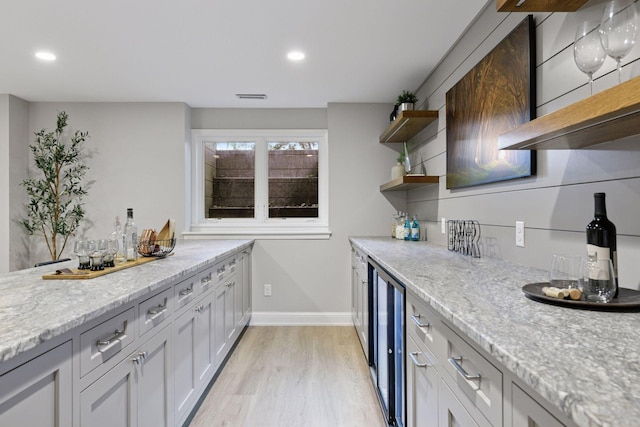 2462 Lafayette Rd, Minnetonka Beach, MN 55391 - kitchen featuring open shelves, light wood finished floors, beverage cooler, recessed lighting, and light stone countertops