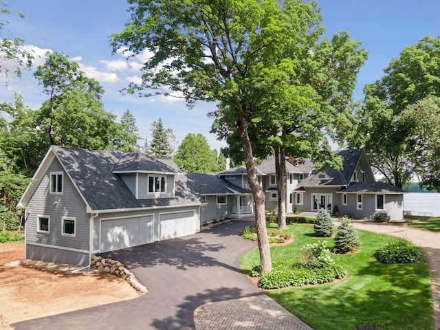 2462 Lafayette Rd, Minnetonka Beach, MN 55391 - view of front of property with driveway, a garage, a front yard, and a shingled roof