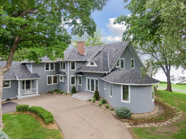 2462 Lafayette Rd, Minnetonka Beach, MN 55391 - view of front of property featuring a shingled roof, driveway, a chimney, covered porch, and french doors