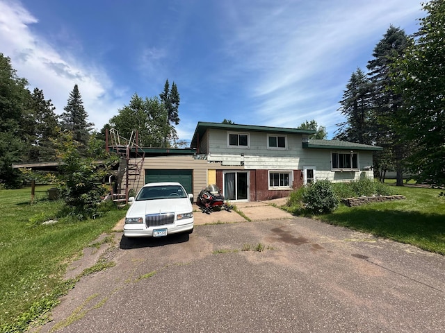 402 Grouse St, Sandstone, MN 55072 - view of front of home with driveway, an attached garage, and a front yard