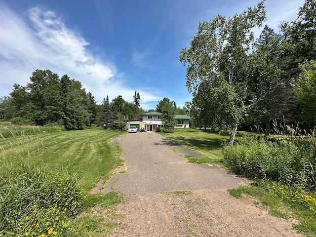 402 Grouse St, Sandstone, MN 55072 - tri-level home with asphalt driveway and a front lawn