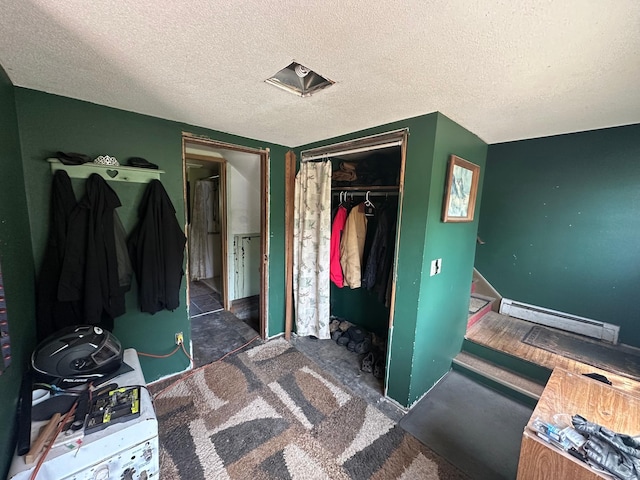 402 Grouse St, Sandstone, MN 55072 - bedroom featuring a baseboard heating unit, a closet, and a textured ceiling