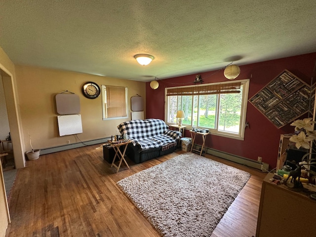 402 Grouse St, Sandstone, MN 55072 - living area with baseboard heating, a textured ceiling, and wood finished floors