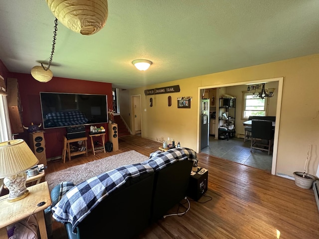 402 Grouse St, Sandstone, MN 55072 - living area with wood finished floors, a textured ceiling, and stairway