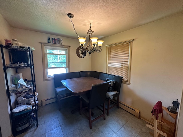 402 Grouse St, Sandstone, MN 55072 - dining room featuring a chandelier, baseboard heating, and a textured ceiling