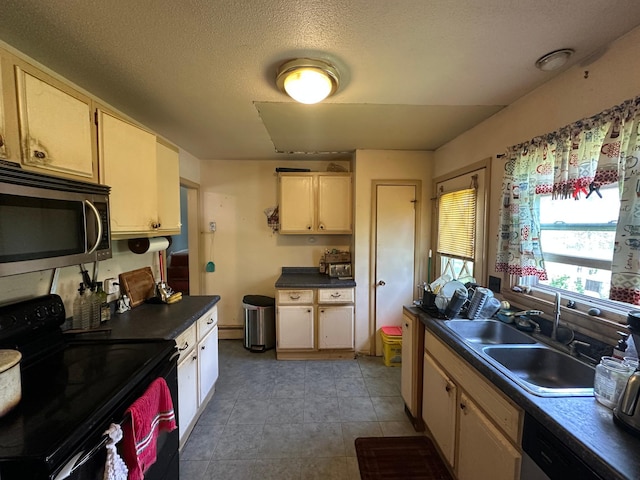 402 Grouse St, Sandstone, MN 55072 - kitchen with stainless steel appliances, dark countertops, a textured ceiling, and light tile patterned flooring