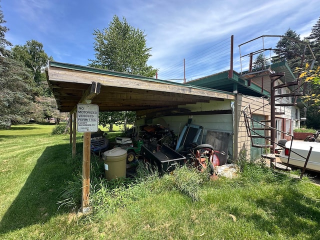 402 Grouse St, Sandstone, MN 55072 - view of side of property with a lawn and a carport