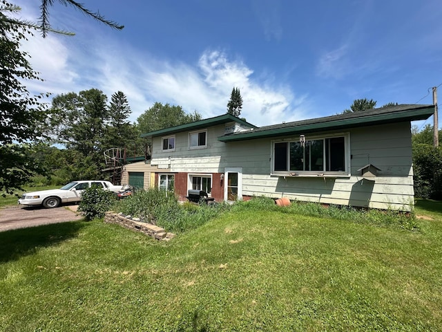 402 Grouse St, Sandstone, MN 55072 - rear view of property featuring a yard