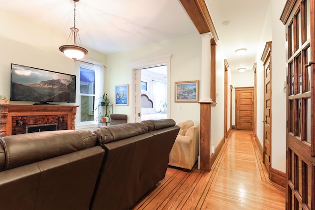 1520 Elliot Ave Unit 4, Minneapolis, MN 55404 - living room with ornate columns, light wood finished floors, and a fireplace