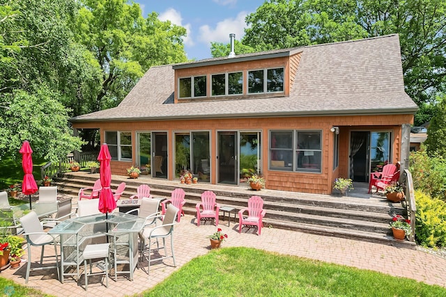 12104 County Highway 17, Lake View Twp, MN 56501 - back of house featuring roof with shingles, a wooden deck, and a patio area