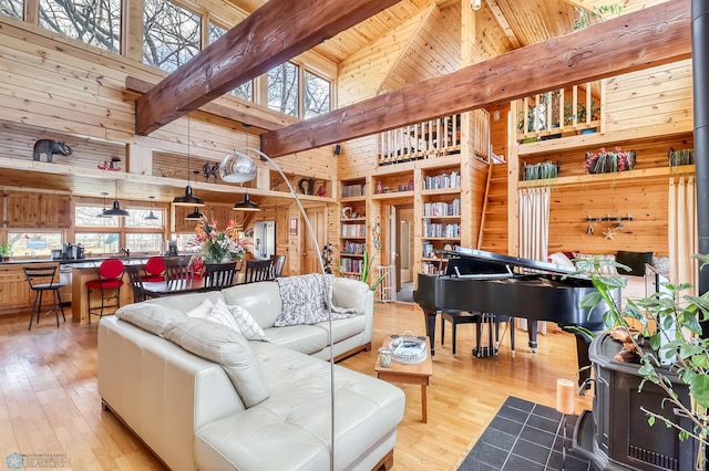 12104 County Highway 17, Lake View Twp, MN 56501 - living area with high vaulted ceiling, wooden walls, hardwood / wood-style floors, and a wooden ceiling with exposed beams