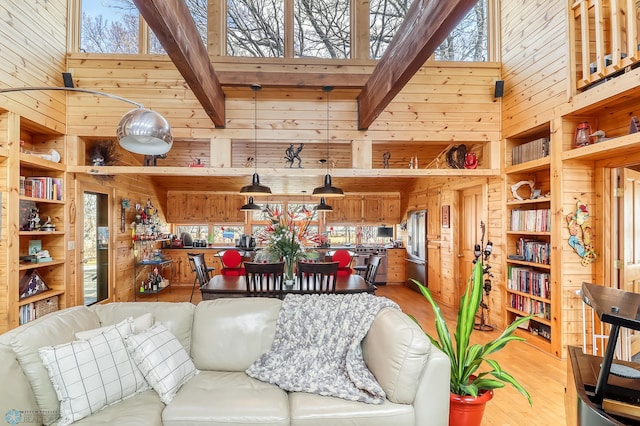 12104 County Highway 17, Lake View Twp, MN 56501 - living room with a towering ceiling, wood walls, light wood finished floors, and beamed ceiling